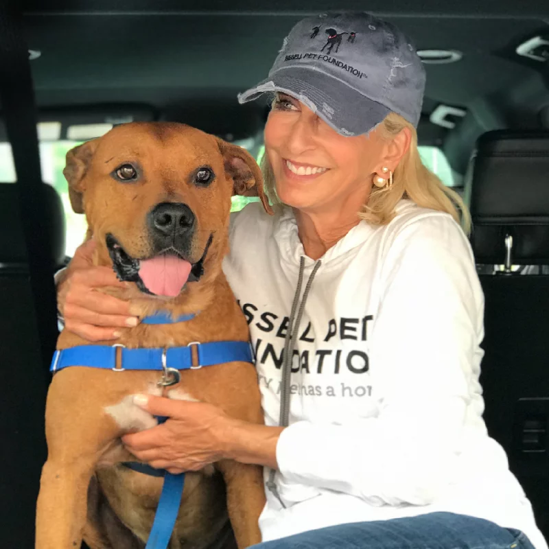 Cathy Bissell and a red pit bull mix dog