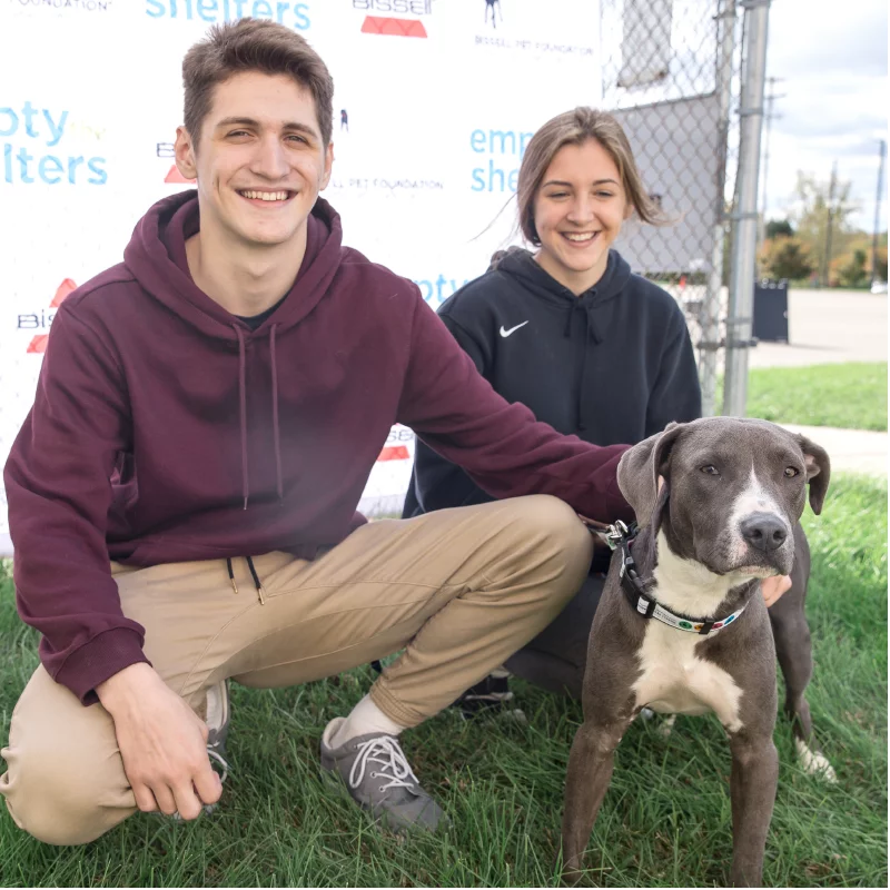 Pit bull mix and his adopters