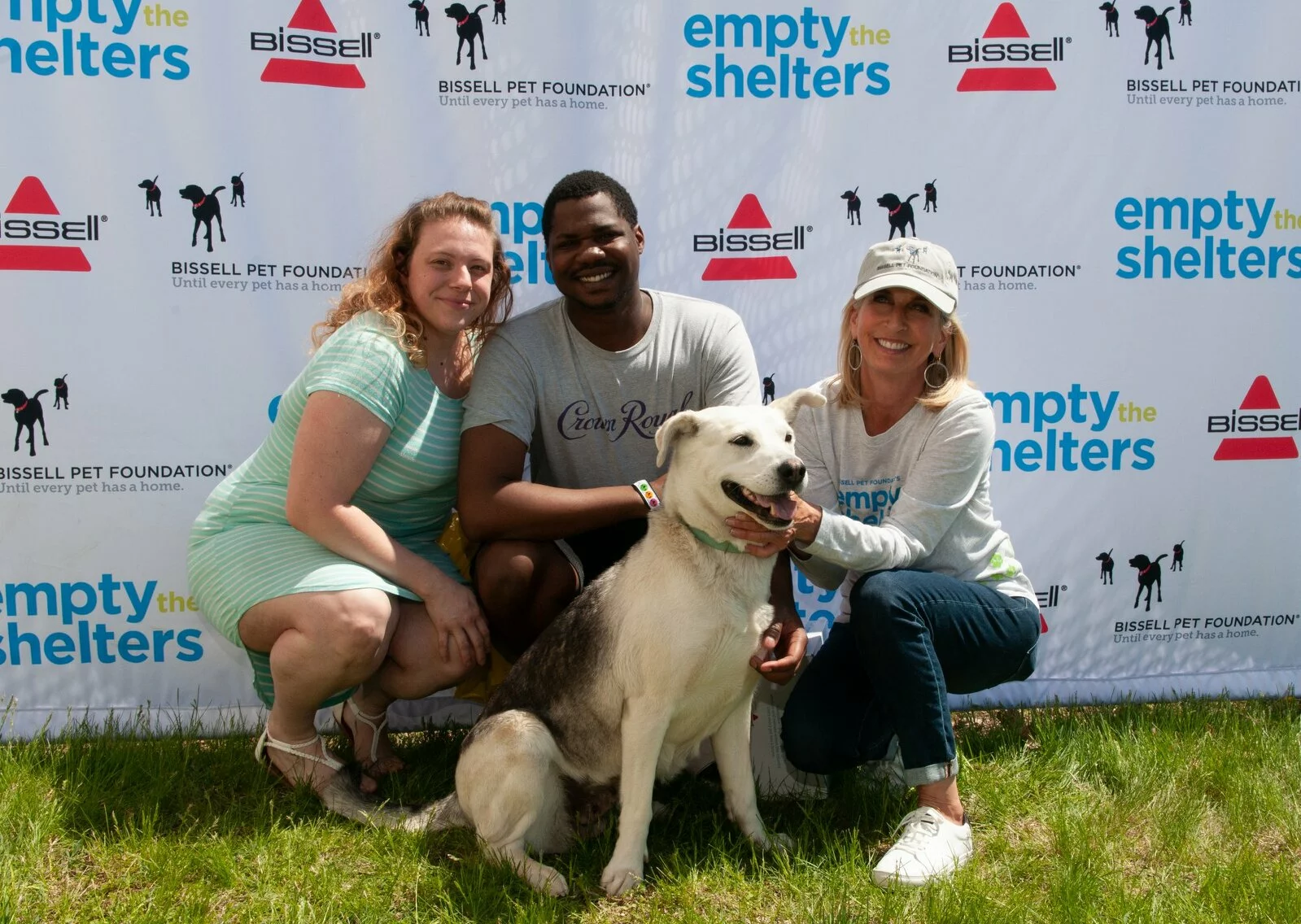 Man, woman and Cathy Bissell with large dog adopted during Empty the Shelters event