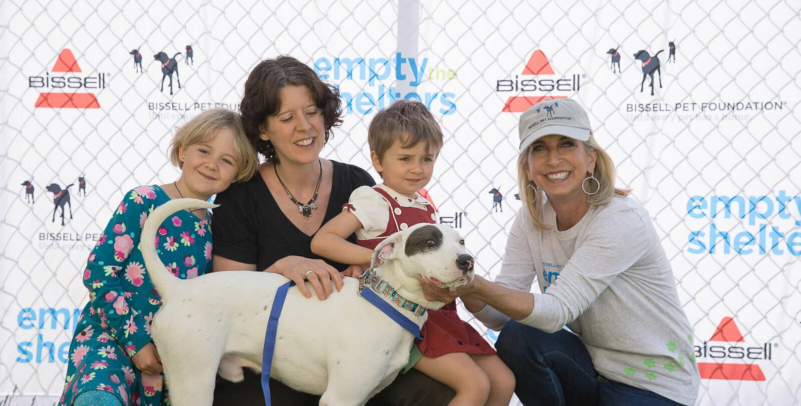 Cathy with young family and a dog at Empty the Shelters event