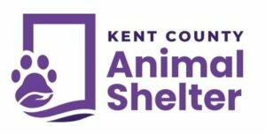 Logo for Kent County Animal Shelter. It features a purple paw print inside a rectangular outline with wavy lines, and the words Kent County Animal Shelter in bold purple text on a white background.
