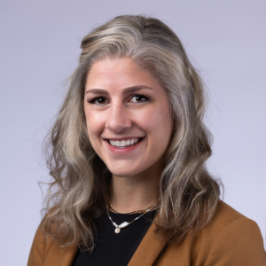 A woman with long hair smiling.
