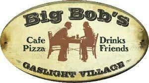 Oval sign for Big Bobs Gaslight Village with silhouettes of two people at a table. Text reads: Cafe, Pizza, Drinks, Friends. The background is beige with brown lettering and accents.